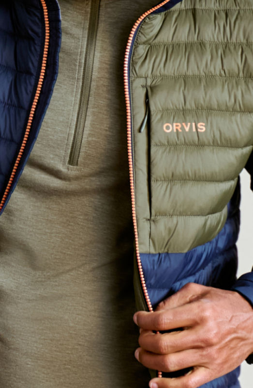 A close-up image of an olive and blue quilted jacket over an olive fleece.