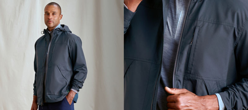 A model wearing a navy jacket over a light blue fleece.