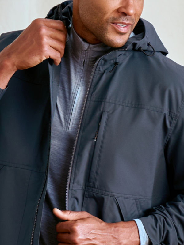 Two image collage: on the left a model wearing a navy jacket and a fabric detail of that jacket on the right.