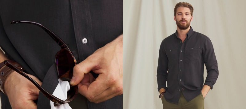 A side by side split image of a model wearing a black button-down shirt over olive pants on the right and a close-up of the model cleaning their sunglasses with the inside corner of the shirt on the left.