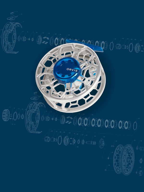 A silver and blue Ratio reel laid against a technical drawing background.