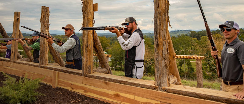 Several men at an outdoor shooting range.