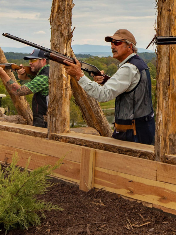 Several men at an outdoor shooting range.