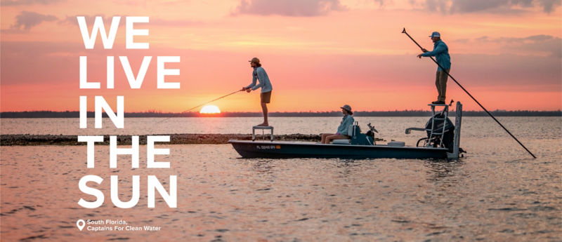 An angler fishes off the front of a boat as the sun fills the sky with color.