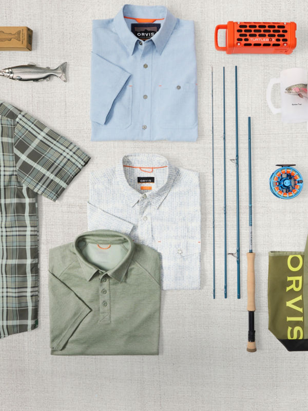 A collection of men's gifts including a Helios fly rod and a variety of shirts.