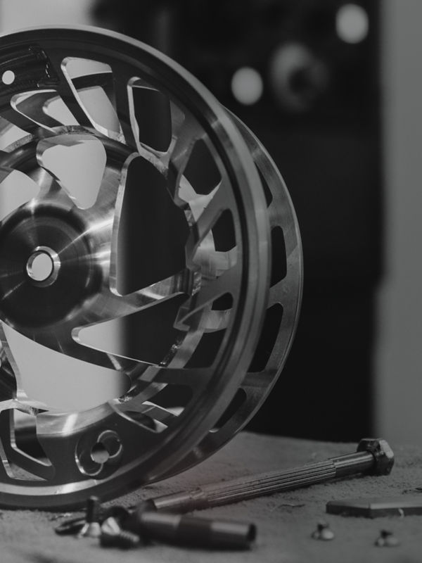 A close view of a reel base without line in black and white.