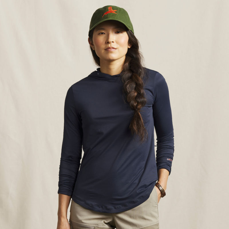 A model wearing a navy sun protection hoodie.