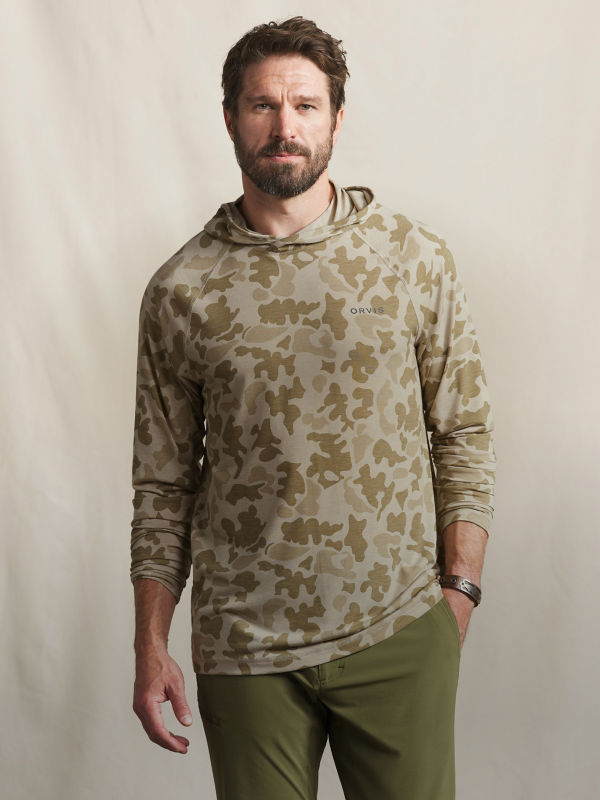 A model wearing an olive camo Men&rsquo;s DriCast Hoodie.