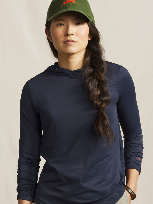 A model wearing a navy Women&rsquo;s Sun Defense Hoodie.