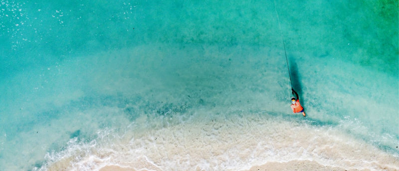 An aerial view of someone casting into beautiful tropical water in Guam.