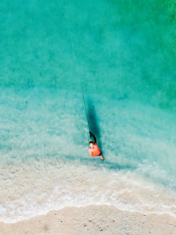 An aerial view of someone casting into beautiful tropical water in Guam.