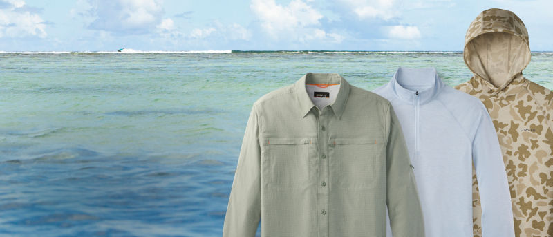 A selection of 3 UPF shirts on a beach horizon background.