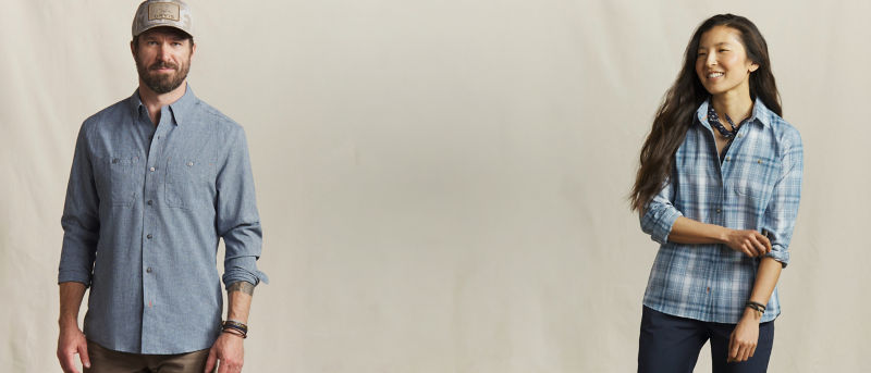 Two models wearing blue button-down tech performance shirts.