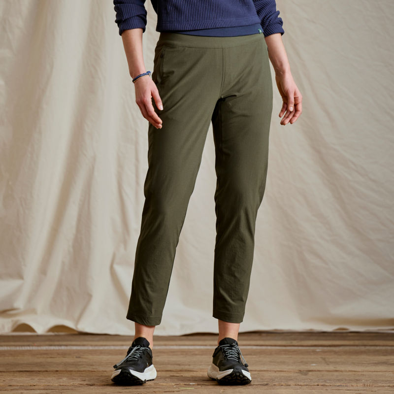 A waist-down view of a model wearing a pair of olive pull-on pants.