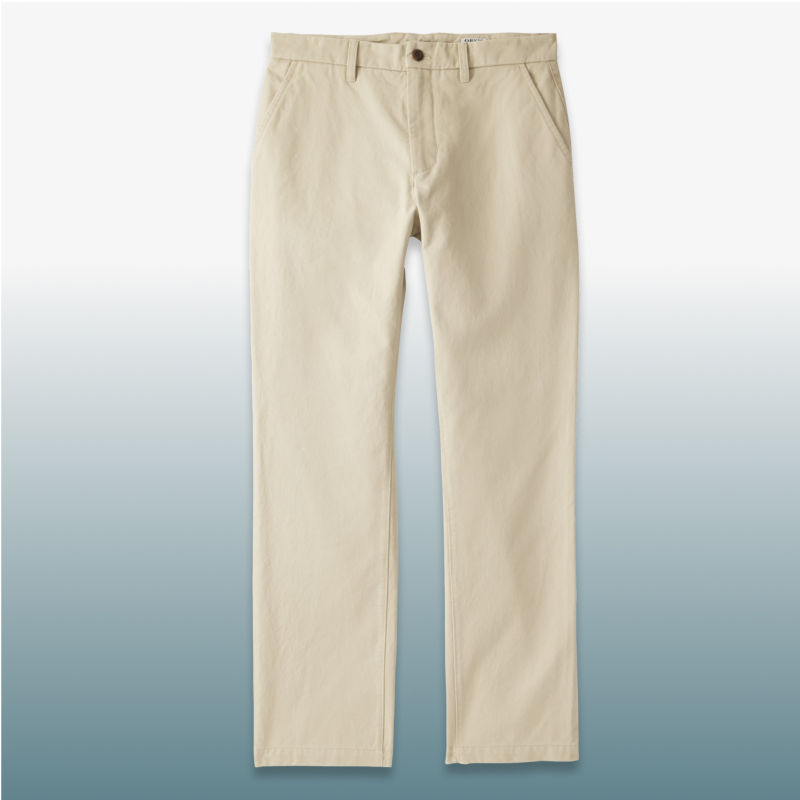 A pair of cream pants laid over a blue gradient background.