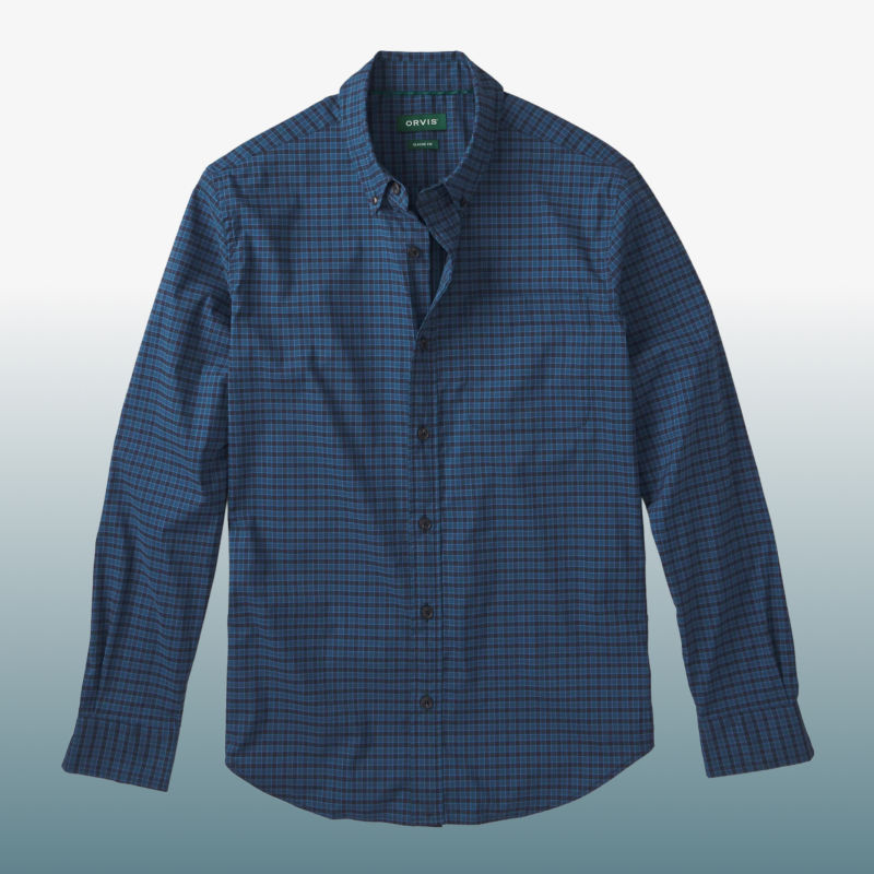 A blue plaid button-down shirt laid over a blue gradient background.