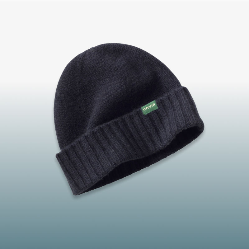 A multi-colored cardigan laid over a blue gradient background.