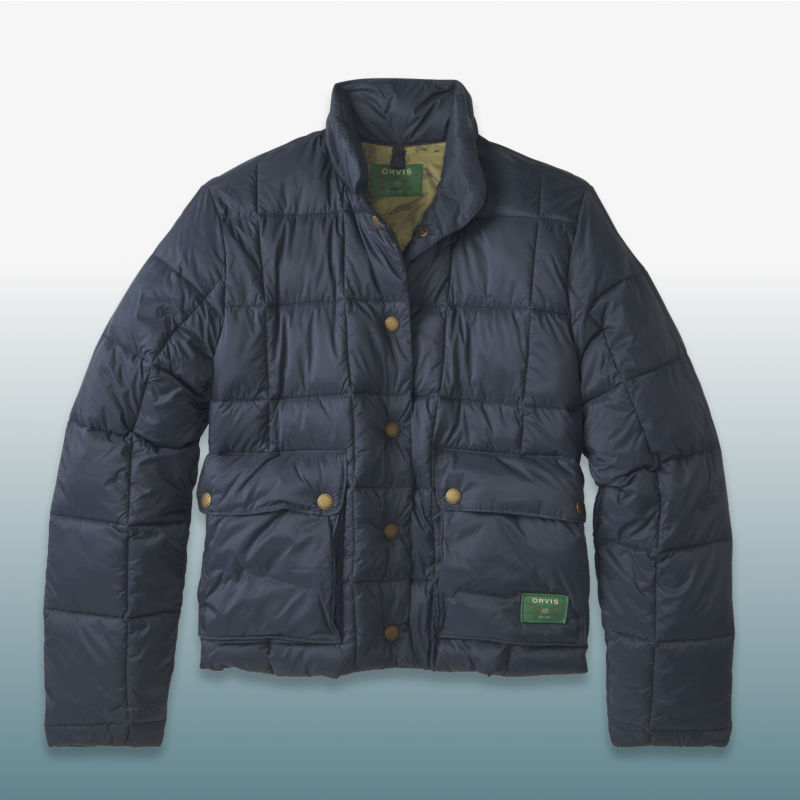 A navy puffed jacket laid over a blue gradient background.