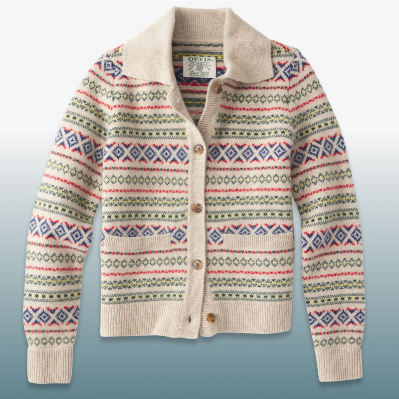 A multi-colored cardigan laid over a blue gradient background.