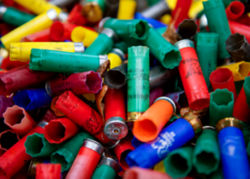 A bright pile of used multicolor shotgun shells