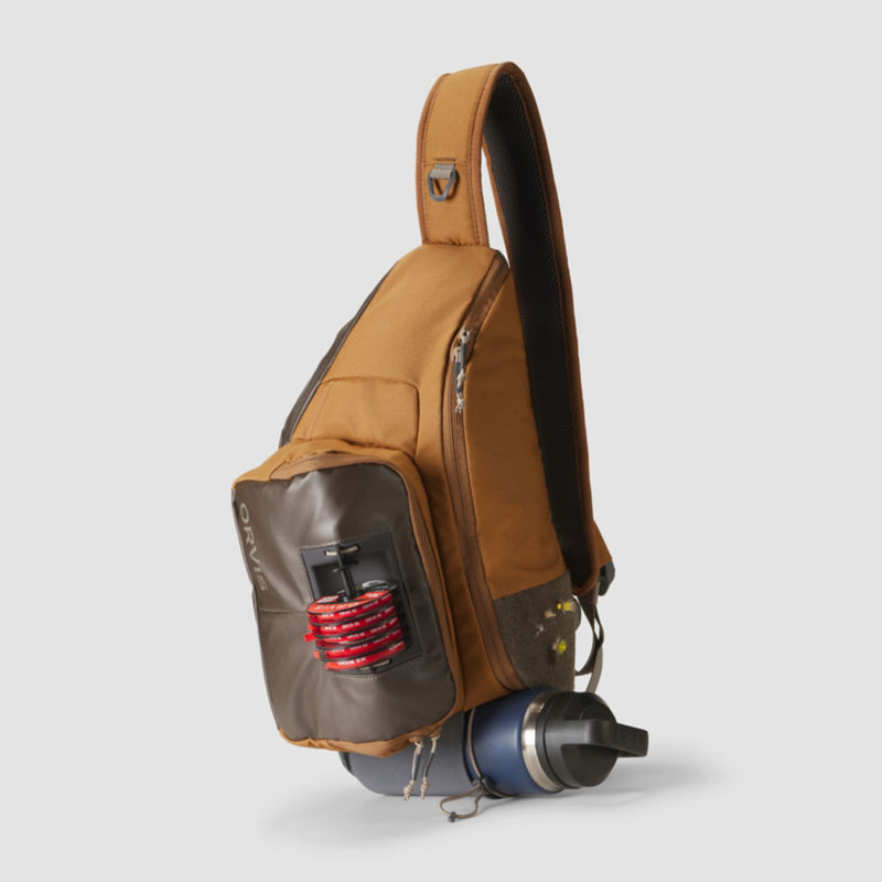 A brown cross body backpack