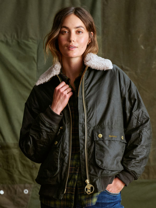 A model wearing a Barbour bomber jacket with fleece collar.