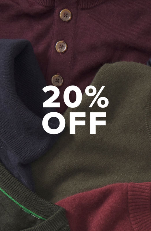 A collection of colorful sweaters piled together.