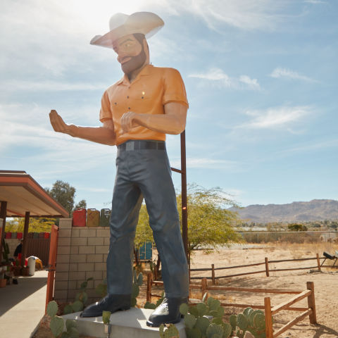 Colorful statue of a man in cowboy hat