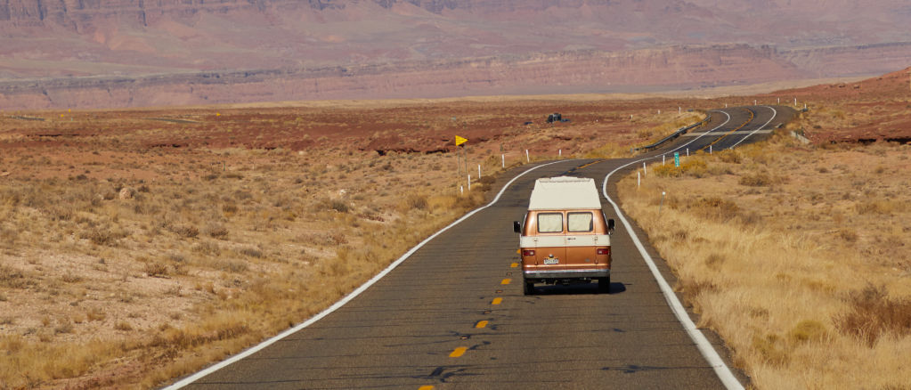 Van driving through the desert.