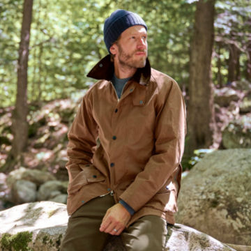 Man in Barbour Classic Beaufort Jacket in Bark in the middle of the woods.