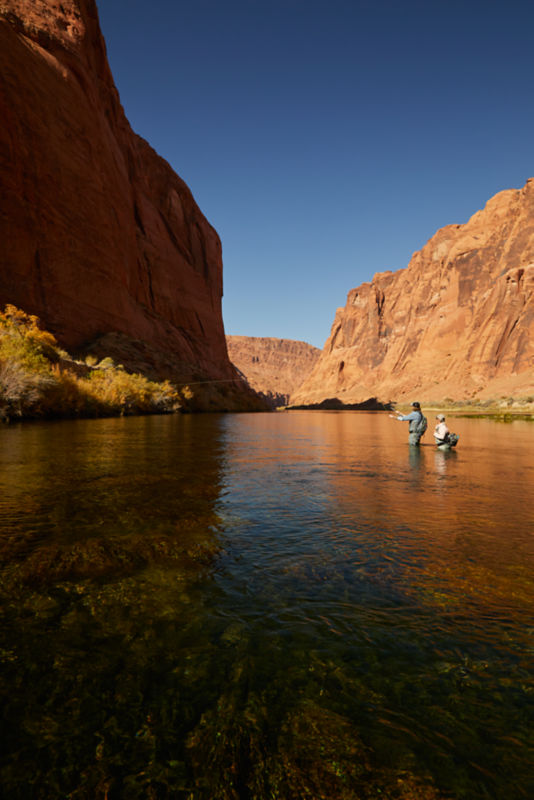 Two men fly fishing on a river