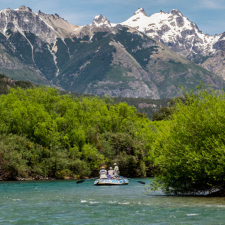 A boat floating down stream in the mountains of Patagonia