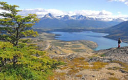 Hiker on mountain overlooks Patagonia