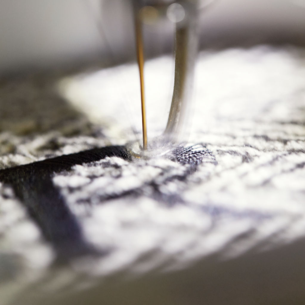 Closeup of personalization needle on sewing machine and fabric