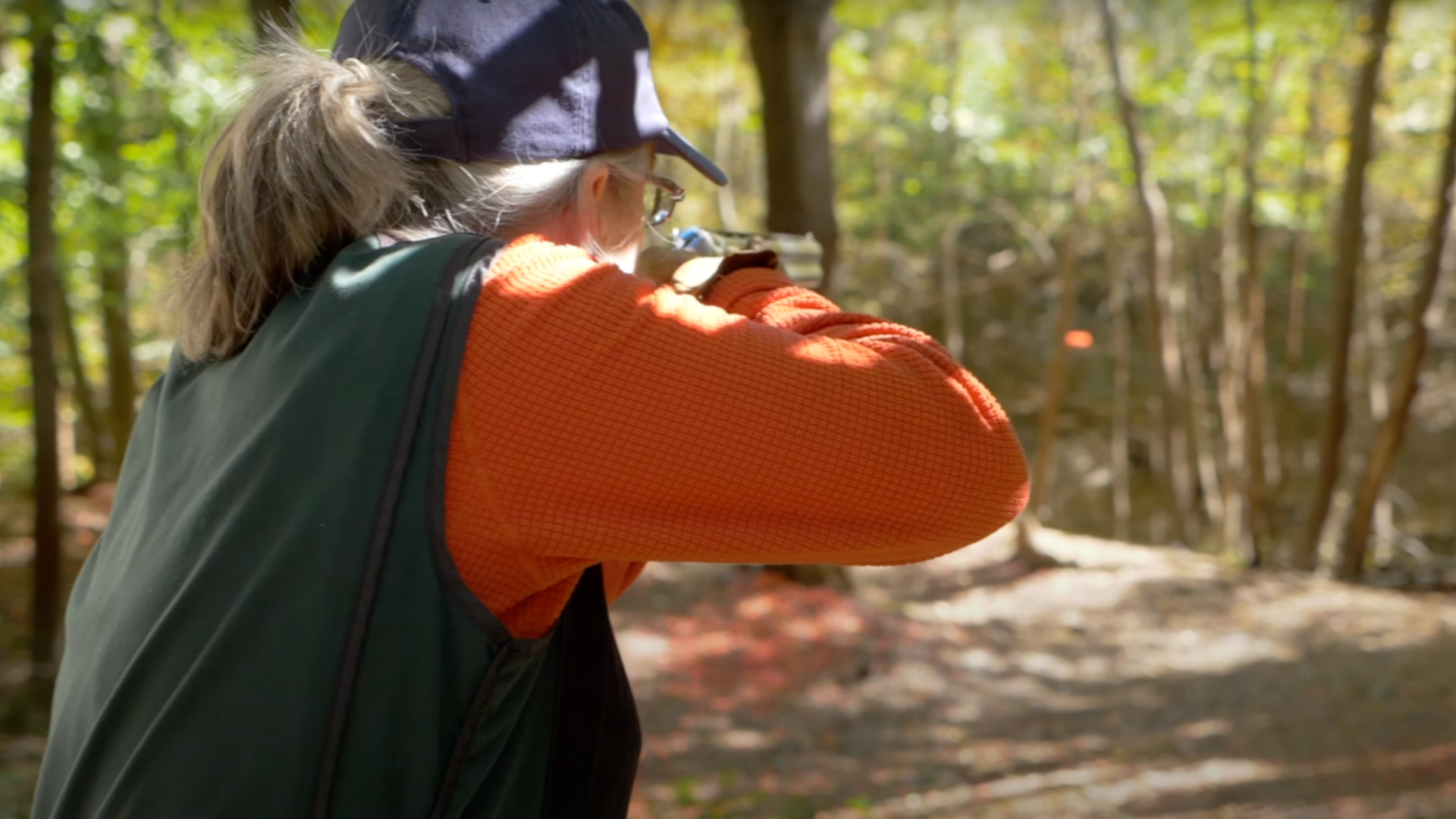 A woman shooting clays off a stand for the Orvis Cup.
