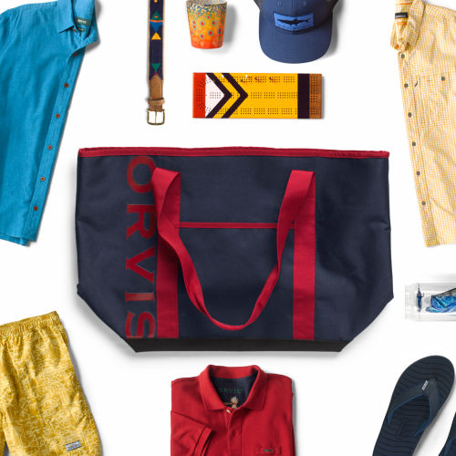 A collection of gifts with a red and blue tote bag in the center.
