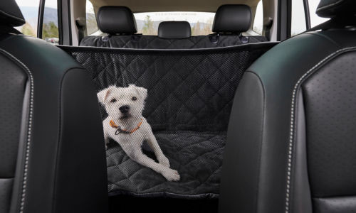 A dog in a Grip-Tight® Windowed Hammock Seat Protector.
