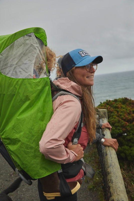 Mother carrying daughter in a backpack