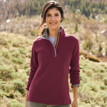 Woman in Signature Softest Print Trim Sweatshirt poses for the camera on top of a grassy knoll.