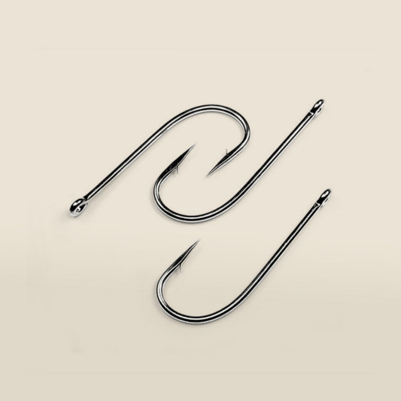 Three fishhooks laid out on a cream background.