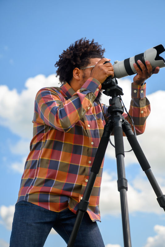 Man with long lens taking photo.