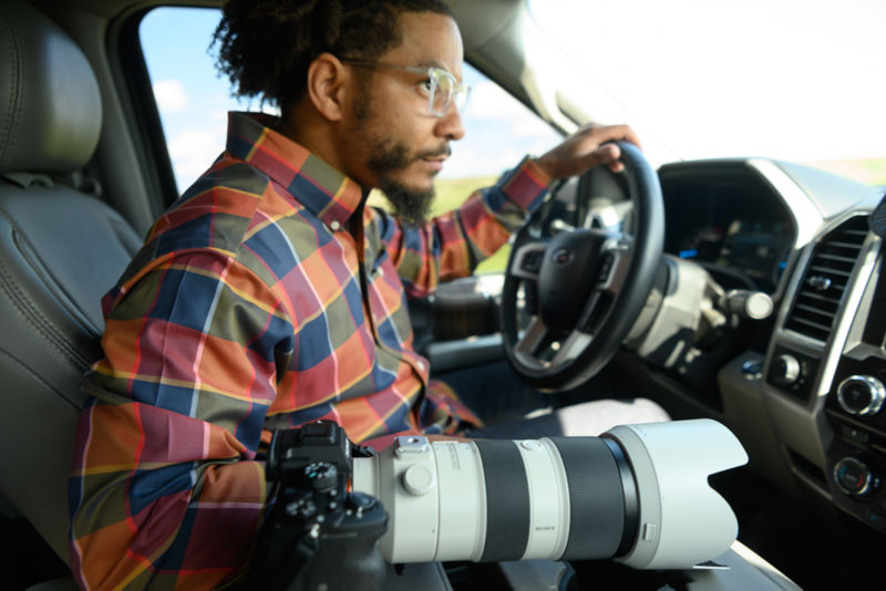 A photographer navigates his vehicle to a location shoot.