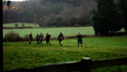 group of men dressed for shooting in an English landscape