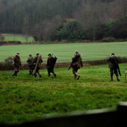 A group of men dressed for shooting in an English landscape
