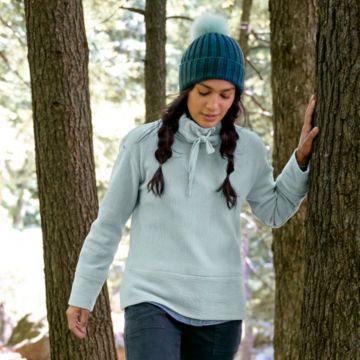 Woman in Textured Cowl Sweatshirt walks through the woods.