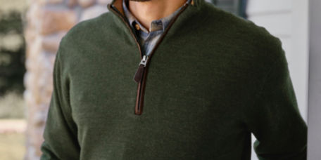 A close-up of a green quarter-zip sweater on a man.