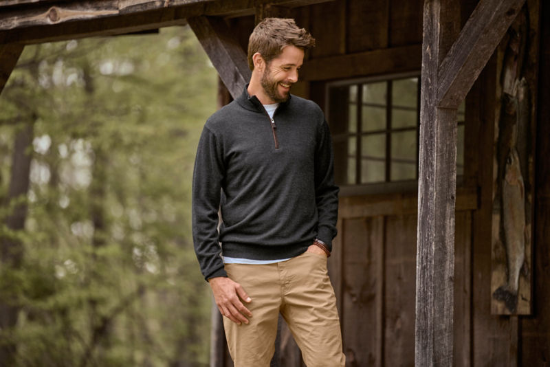 Model outside wearing charcoal 1/4 zip with khakis