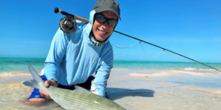 An angler holds a bonefish in the Bahamas