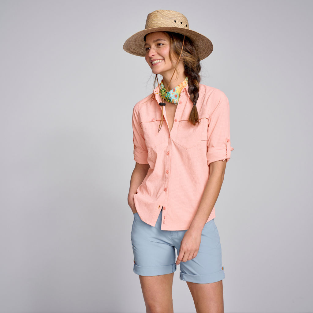Model wearing Long-Sleeved Open Air Caster in clay, Jackson Quick-Dry Natural Fit Convertible 8½" Shorts in blue heron, Hari Mari Fields Puebla Flip Flops in rosette, Palm Straw Island Hat, Arcade Blackwood Slim Belt, and Coolnet® UV+ BUFF.