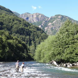 Two anglers standing in a mountain river